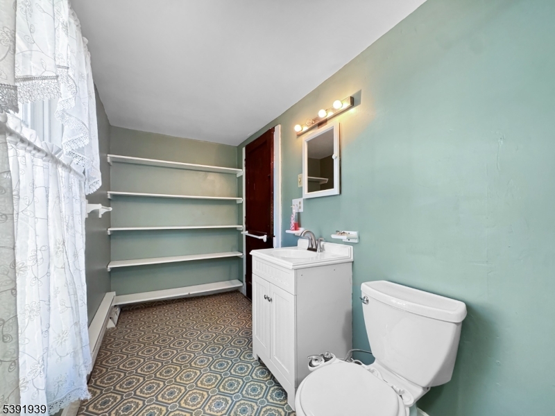 54 Front Street Belvidere, NJ 07823 - Photo 23 of 32 a white toilet sitting next to a bathroom sink