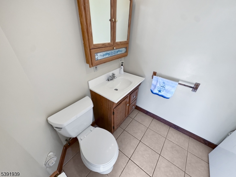 54 Front Street Belvidere, NJ 07823 - Photo 24 of 32 a bathroom with a toilet a sink and mirror