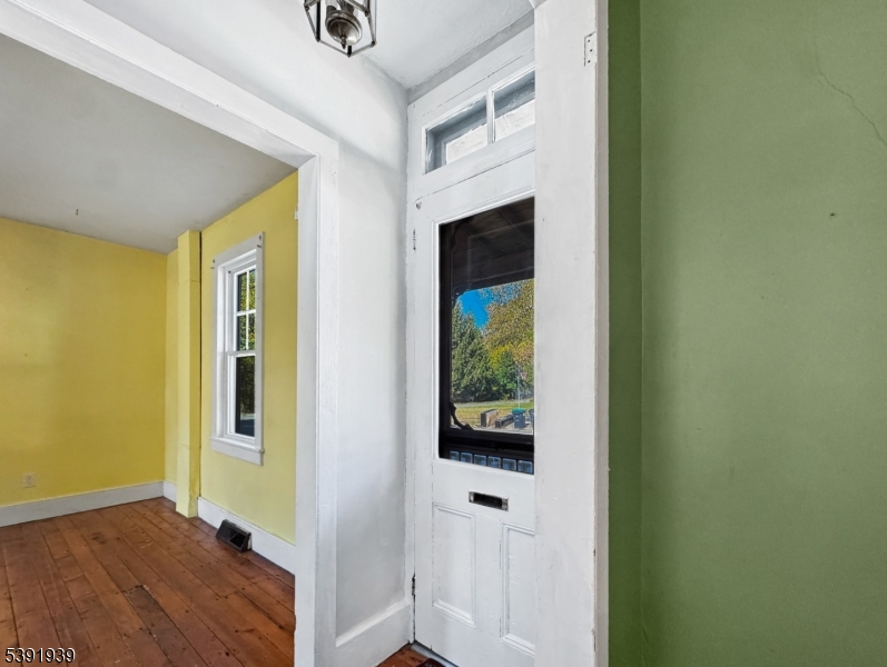54 Front Street Belvidere, NJ 07823 - Photo 4 of 32 a view of a hallway with wooden floor and a bathroom
