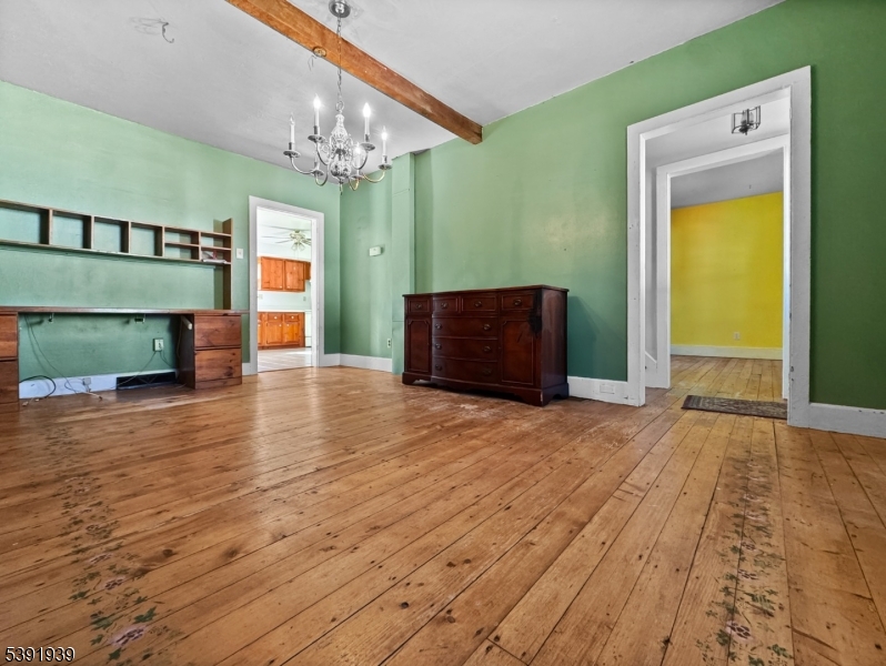 54 Front Street Belvidere, NJ 07823 - Photo 6 of 32 a view of a hallway with wooden floor and a chandelier