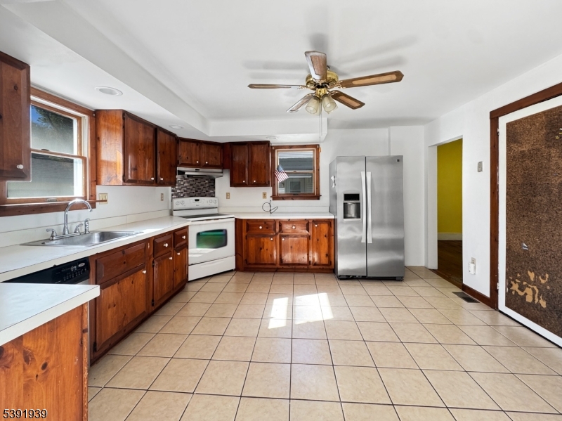 54 Front Street Belvidere, NJ 07823 - Photo 7 of 32 a kitchen with stainless steel appliances granite countertop a sink and cabinets