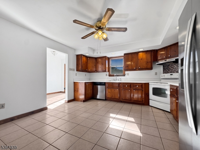 54 Front Street Belvidere, NJ 07823 - Photo 9 of 32 a kitchen with stainless steel appliances a sink a stove a microwave a counter top space and cabinets
