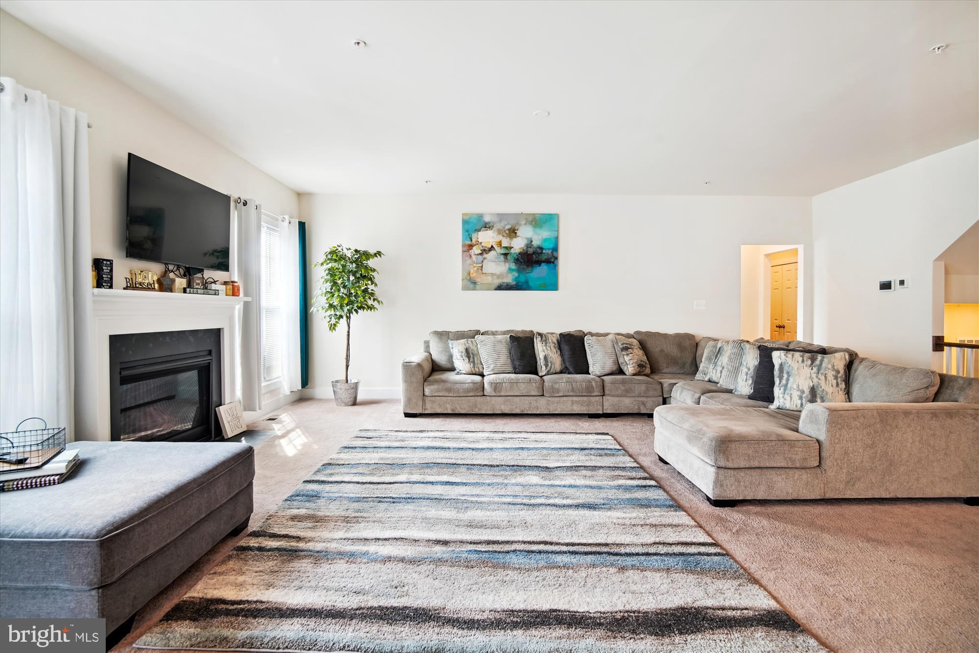 12600 Abercorn Place Brandywine, MD 20613 - Photo 15 of 43 a living room with furniture fireplace and flat screen tv
