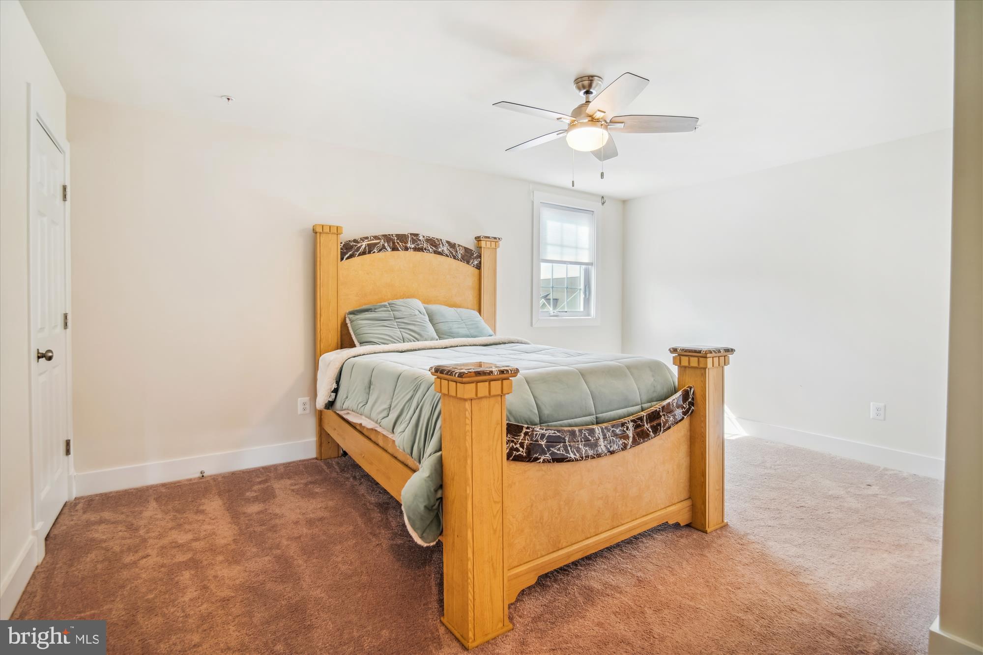 12600 Abercorn Place Brandywine, MD 20613 - Photo 32 of 43 a spacious bedroom with a bed and a chandelier