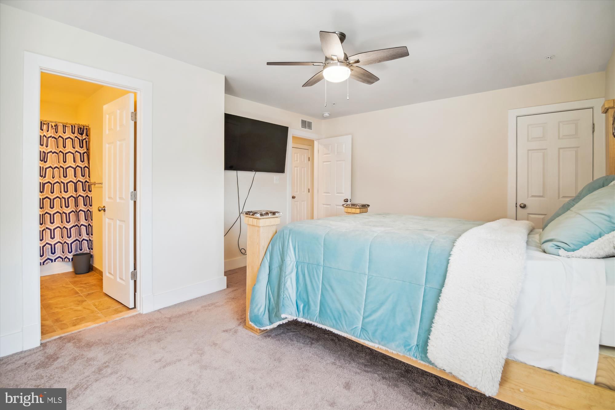 12600 Abercorn Place Brandywine, MD 20613 - Photo 33 of 43 a bedroom with a bed and a flat screen tv