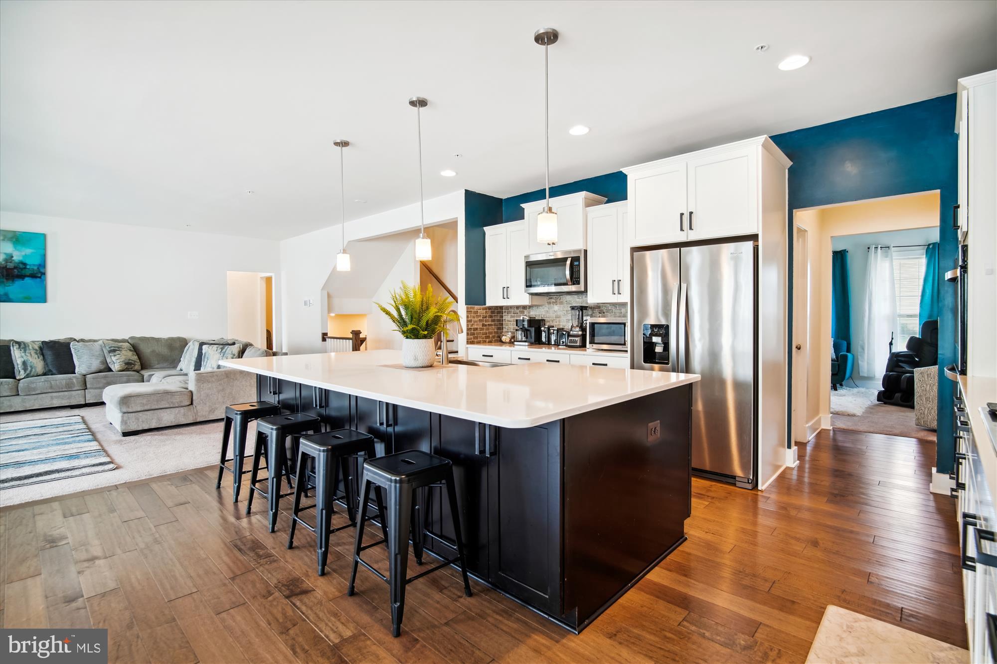 12600 Abercorn Place Brandywine, MD 20613 - Photo 6 of 43 a kitchen with stainless steel appliances granite countertop a table chairs and a refrigerator
