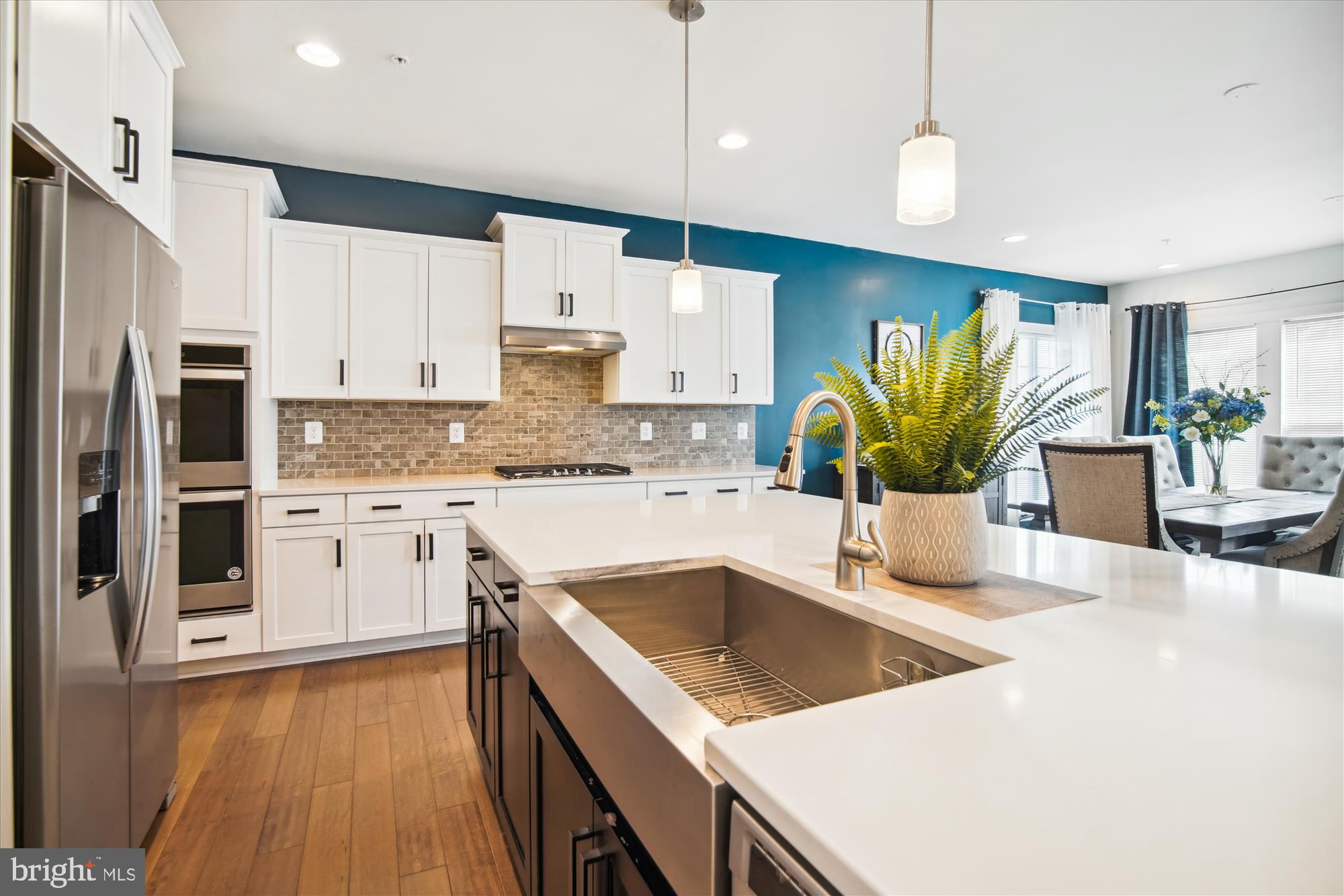 12600 Abercorn Place Brandywine, MD 20613 - Photo 8 of 43 a kitchen with stainless steel appliances granite countertop a sink a stove and a refrigerator