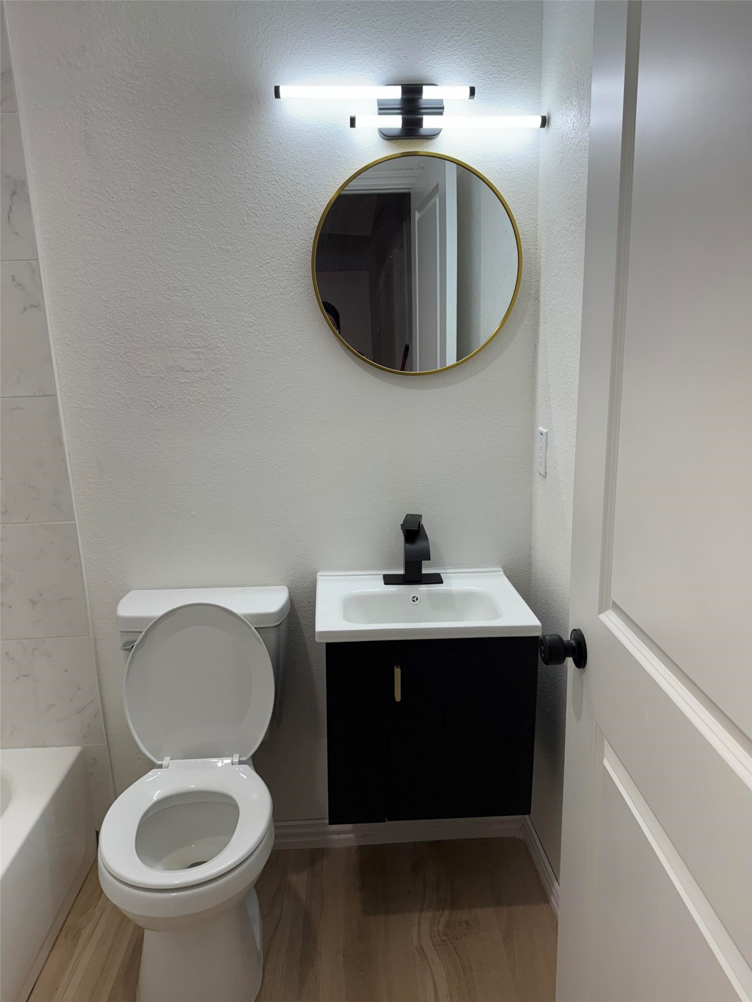 12939 Segrest Drive Houston, TX 77047 - Photo 11 of 12 a bathroom with a toilet a sink and mirror