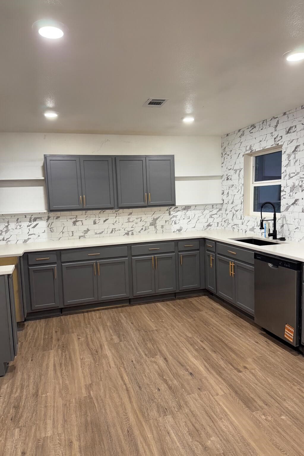 12939 Segrest Drive Houston, TX 77047 - Photo 2 of 12 a kitchen with stainless steel appliances kitchen island granite countertop a sink and cabinets