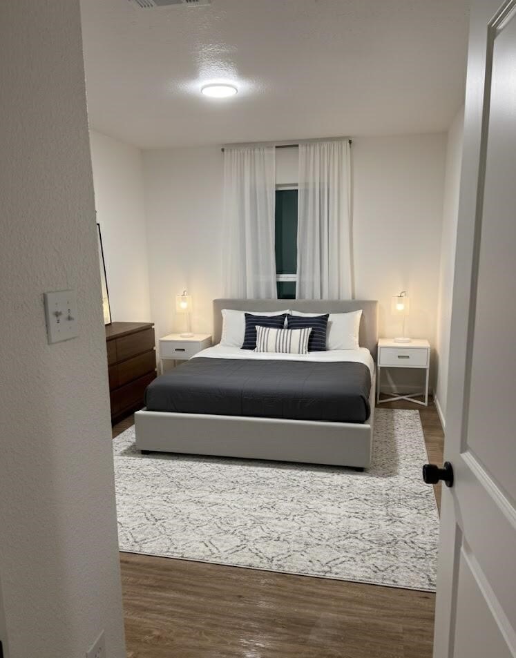 12939 Segrest Drive Houston, TX 77047 - Photo 6 of 12 a bedroom with a bed and window