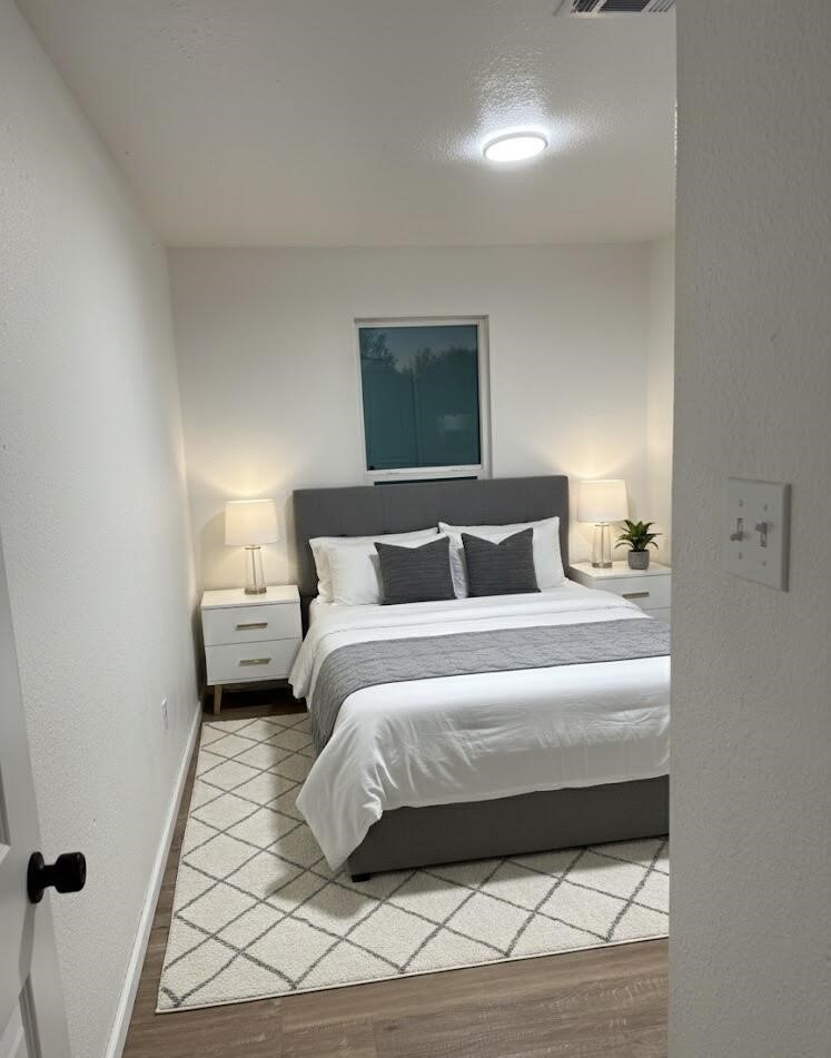 12939 Segrest Drive Houston, TX 77047 - Photo 7 of 12 a bedroom with a bed and a night stand