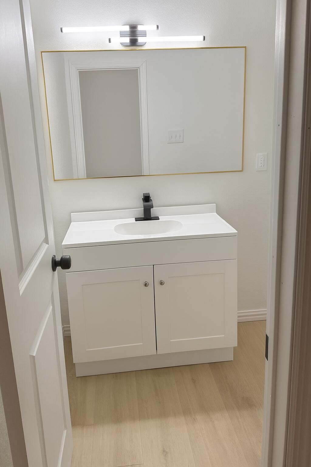 12939 Segrest Drive Houston, TX 77047 - Photo 8 of 12 a bathroom with a sink and a mirror