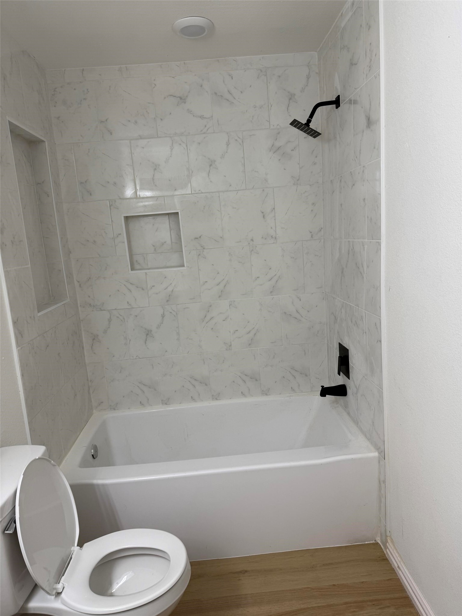 12939 Segrest Drive Houston, TX 77047 - Photo 9 of 12 a bathroom with a toilet bathtub and shower