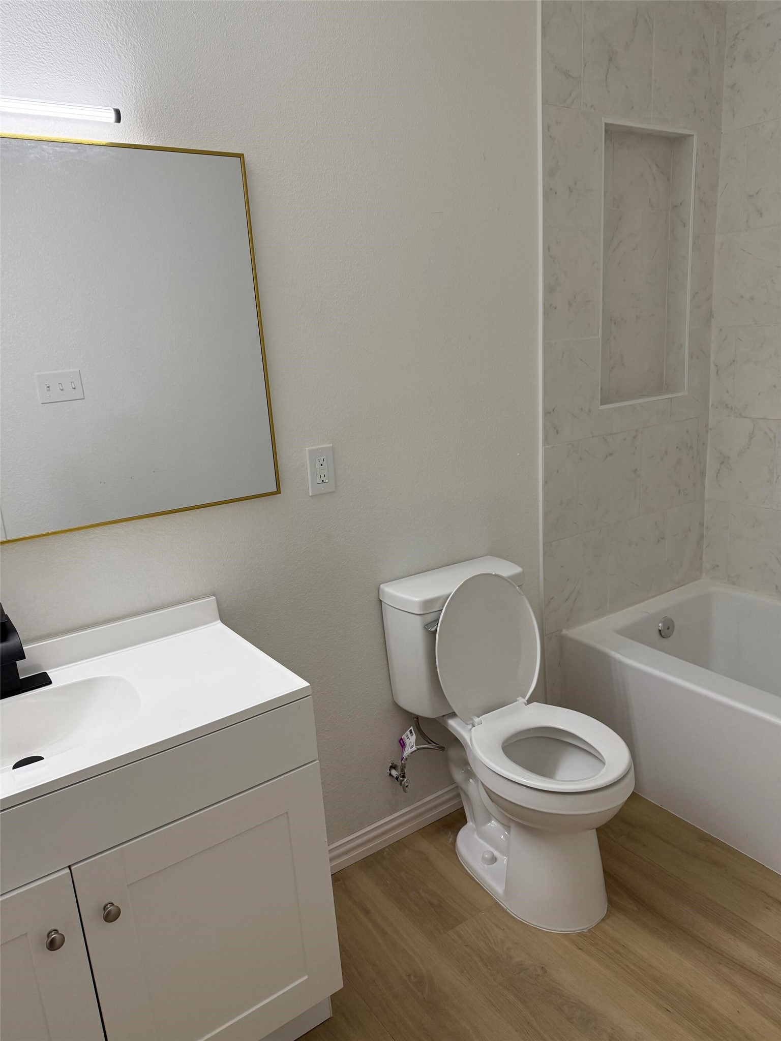 12939 Segrest Drive Houston, TX 77047 - Photo 10 of 12 a white toilet sitting next to a bathroom sink