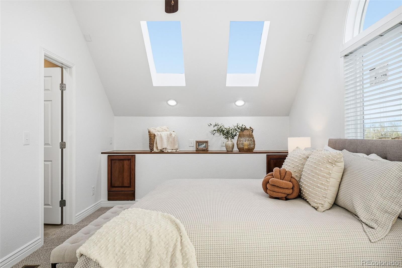 1661 Trenton Street Denver, CO 80220 - Photo 22 of 50 a spacious bedroom with a bed and window