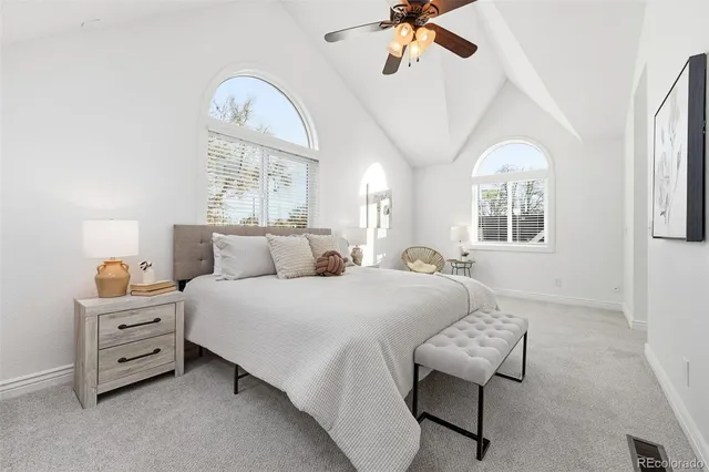 a bedroom with a large bed and a window