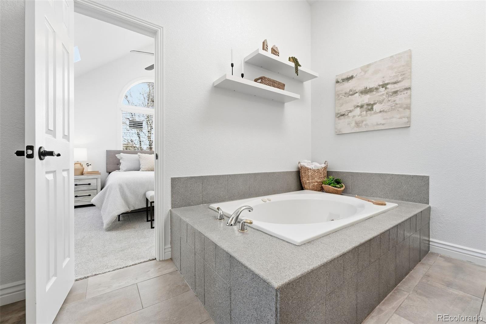 1661 Trenton Street Denver, CO 80220 - Photo 27 of 50 a en suite bathroom with a bathtub and window