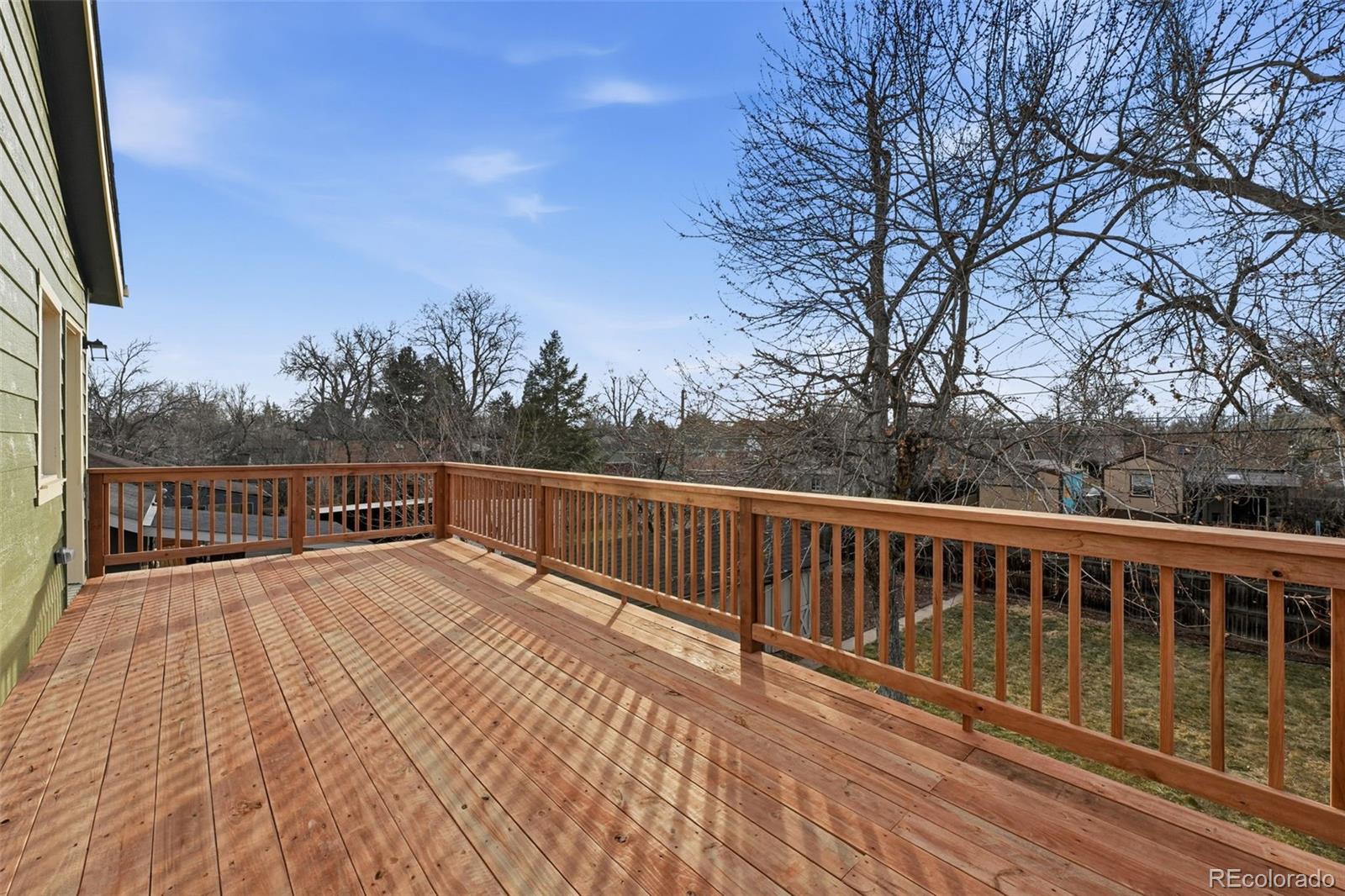1661 Trenton Street Denver, CO 80220 - Photo 33 of 50 a view of balcony with wooden floor and fence