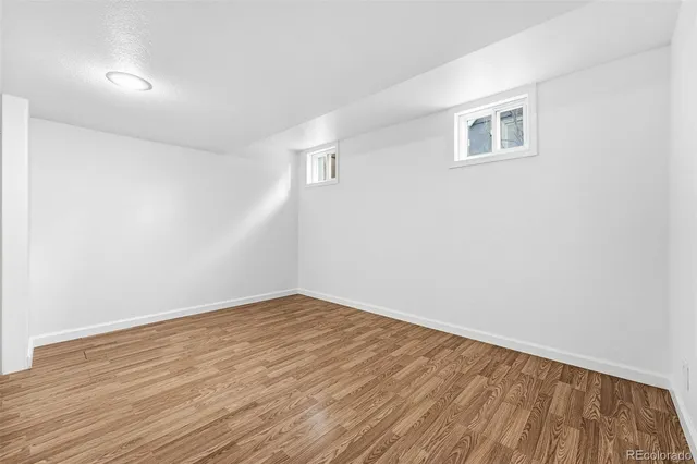 a view of a room with wooden floor