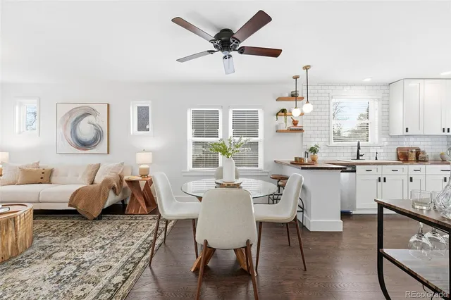 a dining room with wooden floor and a chandelier