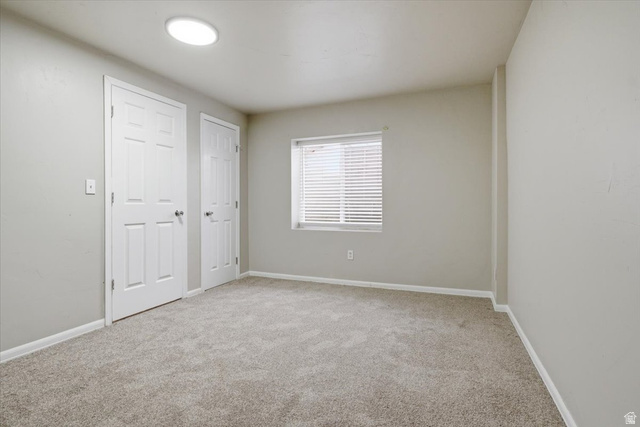 4496 West 11800 South South Jordan, UT 84009 - Photo 29 of 33 Unfurnished bedroom with light colored carpet and baseboards