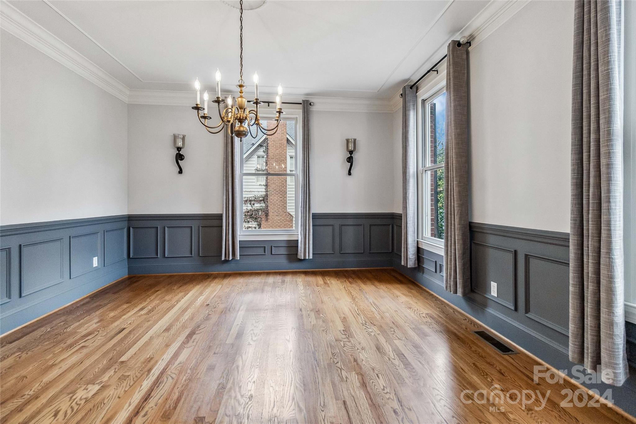 2410 Sharon Road Charlotte, NC 28211 - Photo 11 of 32 a view of a room with wooden floor and chandelier