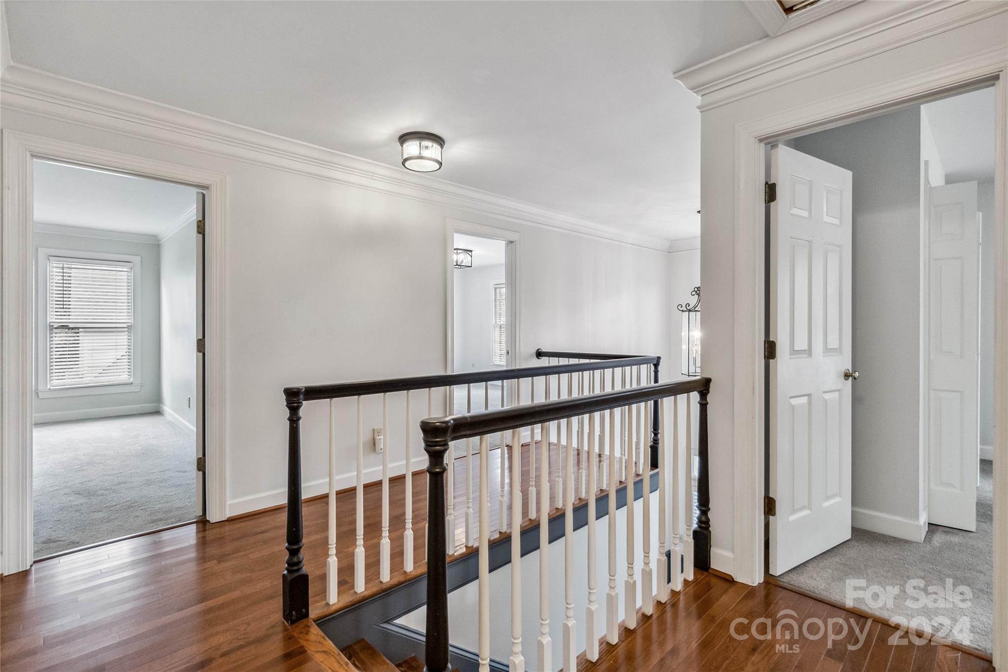 2410 Sharon Road Charlotte, NC 28211 - Photo 16 of 32 a view of hallway with stairs and wooden floor