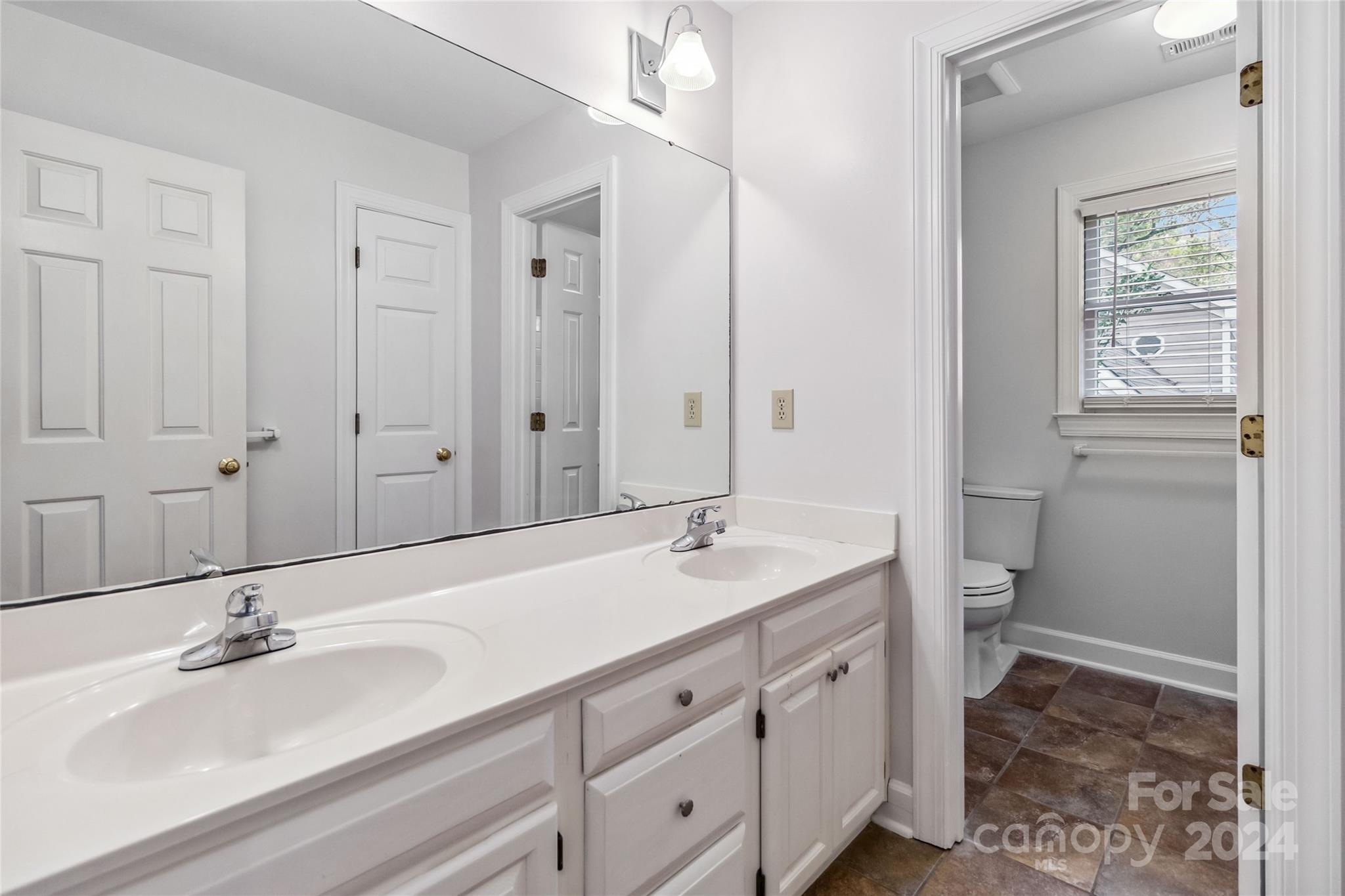 2410 Sharon Road Charlotte, NC 28211 - Photo 19 of 32 a spacious bathroom with a granite countertop sink and a mirror