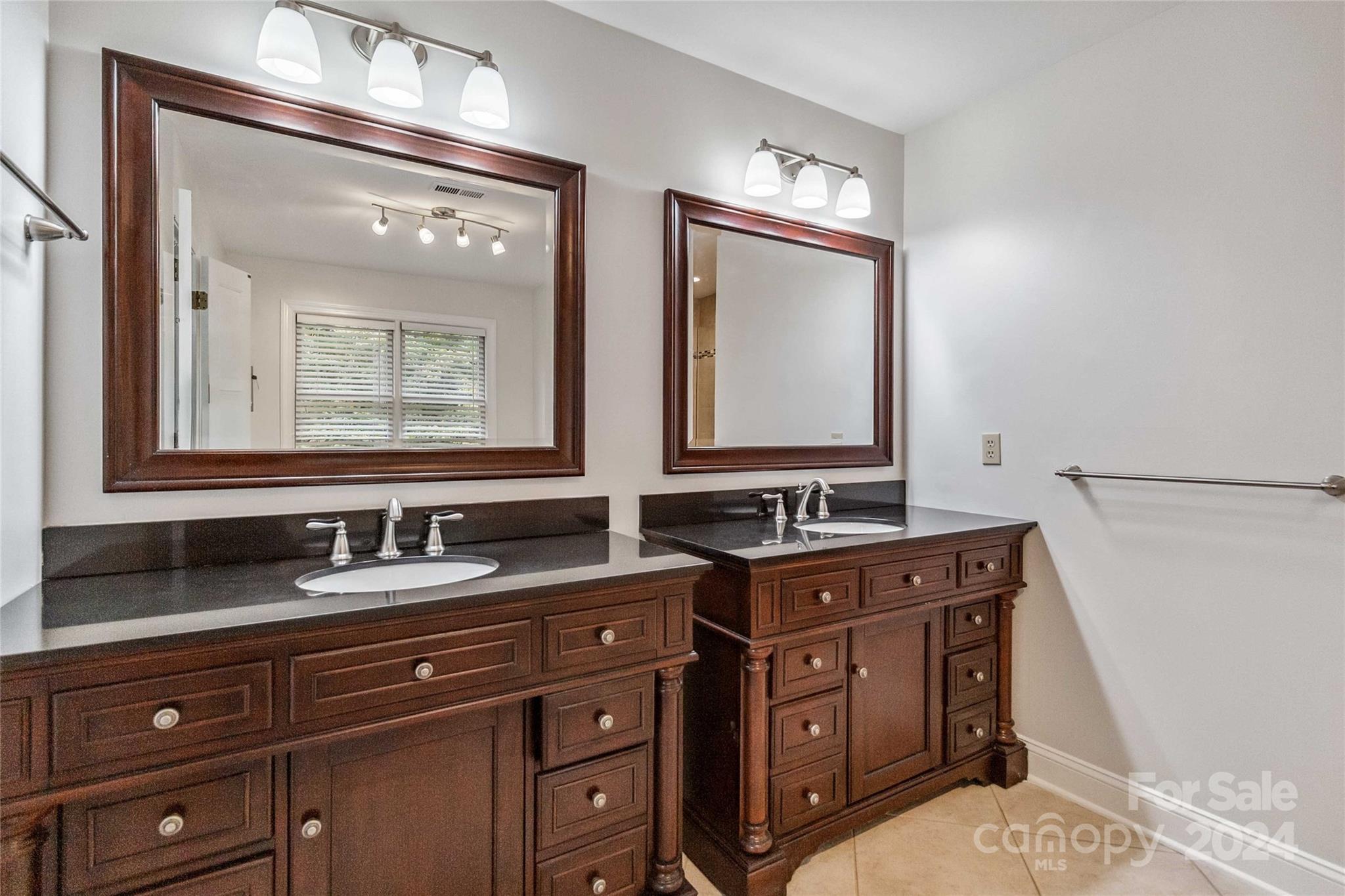 2410 Sharon Road Charlotte, NC 28211 - Photo 24 of 32 a bathroom with a sink and a mirror