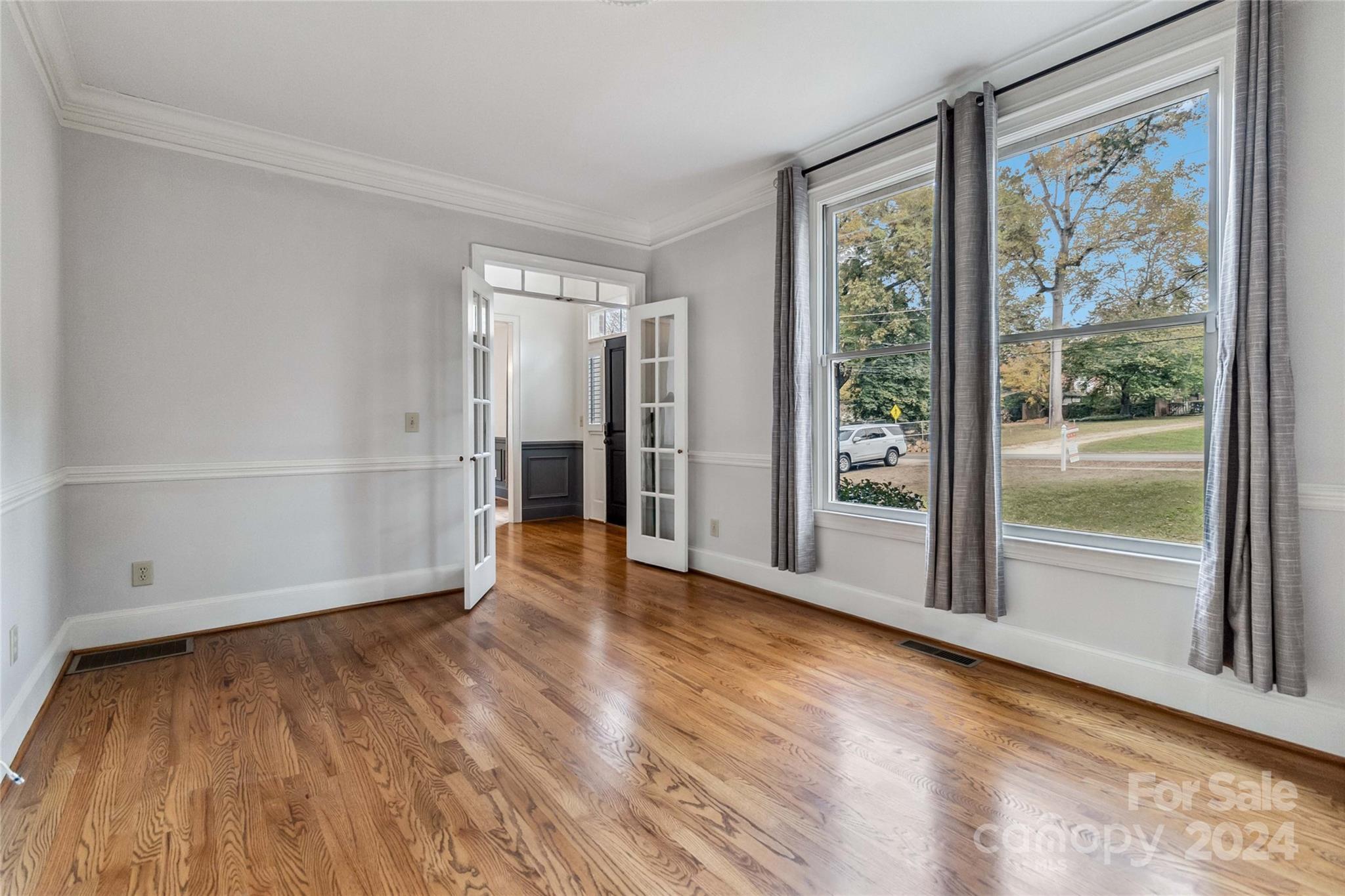 2410 Sharon Road Charlotte, NC 28211 - Photo 8 of 32 a view of empty room with wooden floor and fan