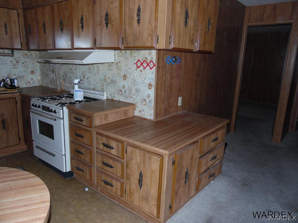 5654 Pasadena Road Fort Mohave, AZ 86426 - Photo 8 of 17 a kitchen with a stove and a refrigerator