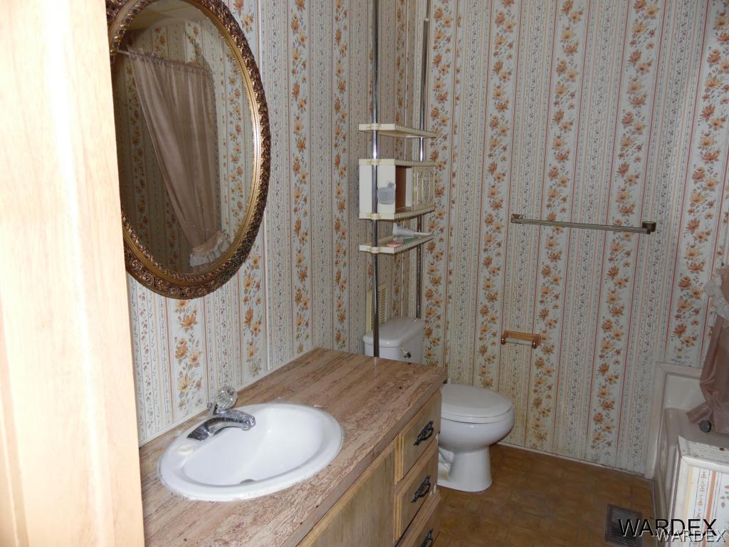 5654 Pasadena Road Fort Mohave, AZ 86426 - Photo 10 of 17 a bathroom with a sink a toilet and shower