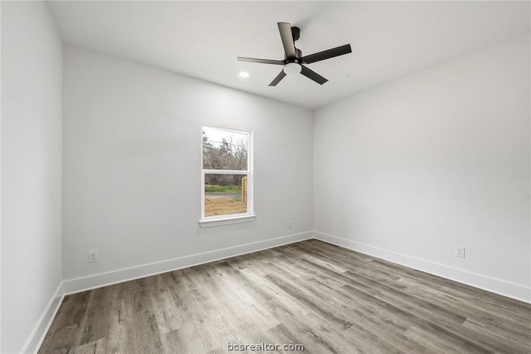 203 Lock Lane Bryan, TX 77803 - Photo 11 of 22 an empty room with a window and a ceiling fan