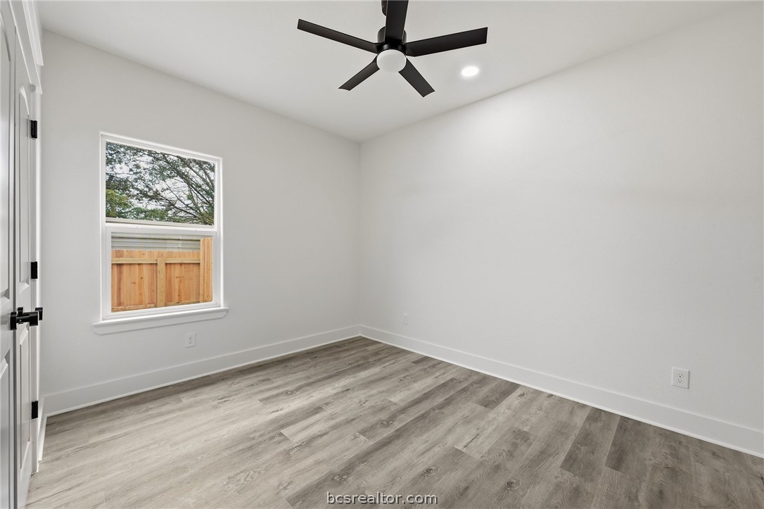 203 Lock Lane Bryan, TX 77803 - Photo 13 of 22 an empty room with a window and a ceiling fan