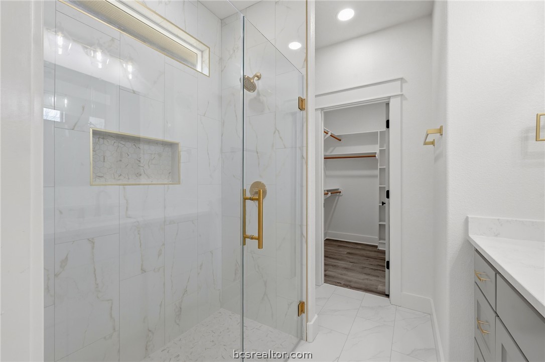 203 Lock Lane Bryan, TX 77803 - Photo 18 of 22 a bathroom with a shower and a sink