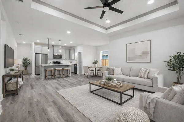 a living room with furniture and kitchen view