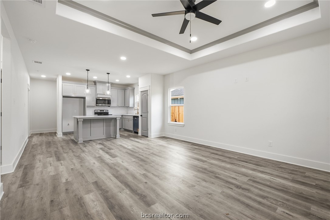 203 Lock Lane Bryan, TX 77803 - Photo 4 of 22 a view of kitchen with refrigerator microwave and stove
