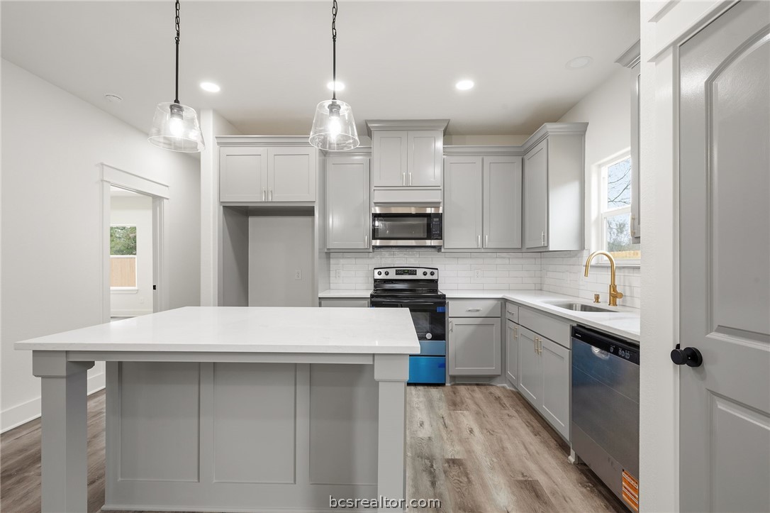 203 Lock Lane Bryan, TX 77803 - Photo 8 of 22 a kitchen with kitchen island a sink stainless steel appliances and cabinets