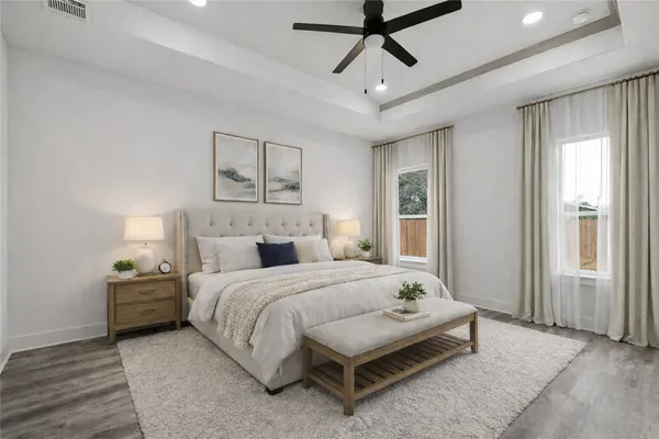a bedroom with a bed chandelier and a window