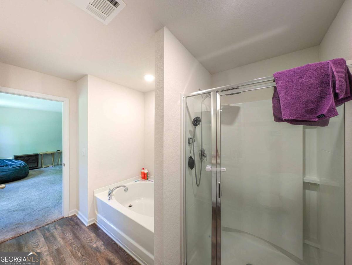 653 Meadows Farm Way Monroe, GA 30655 - Photo 23 of 34 a bathroom with a tub shower and a sink