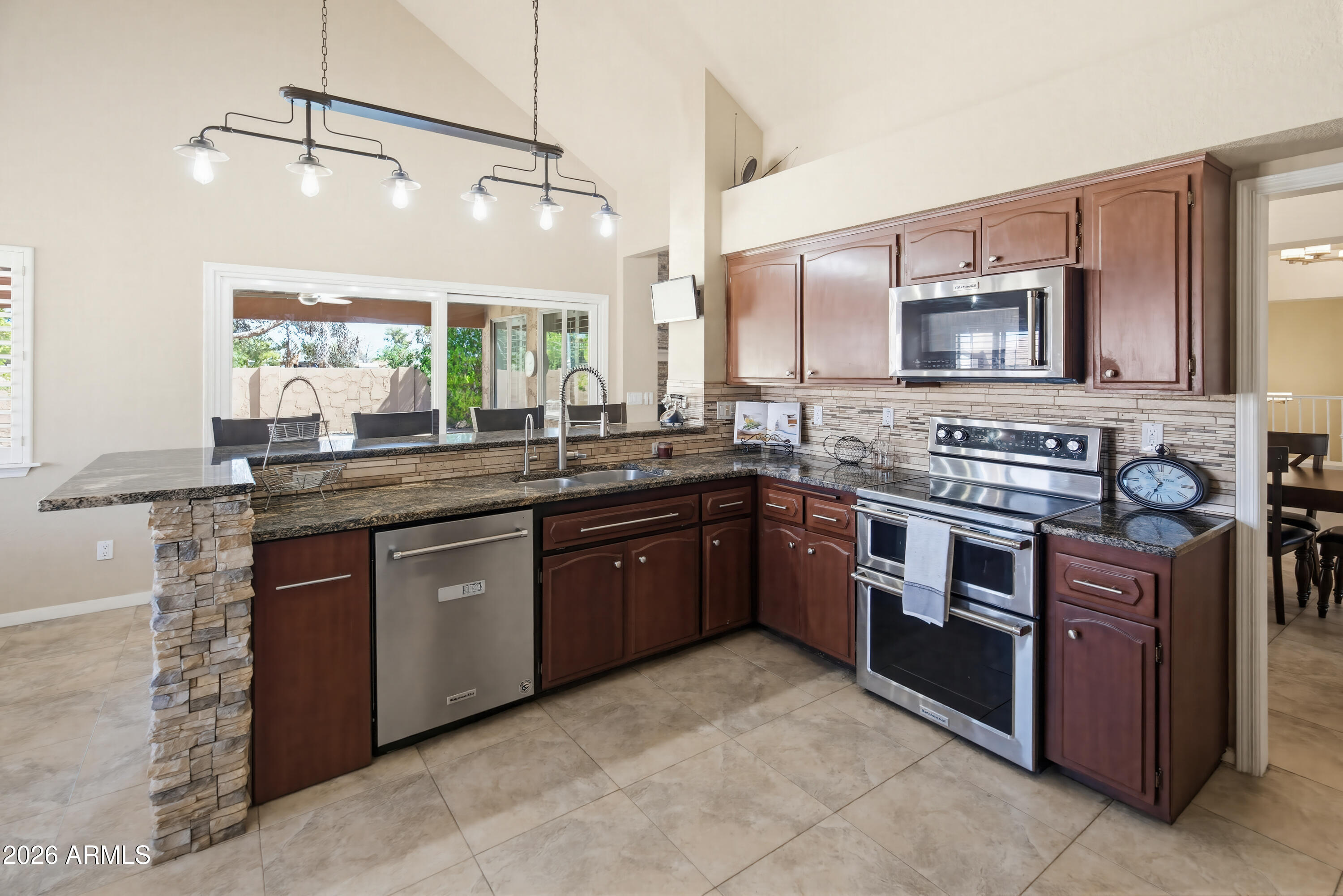 841 North Gentry Mesa, AZ 85213 - Photo 14 of 74 a kitchen with stainless steel appliances granite countertop a stove a sink and a microwave