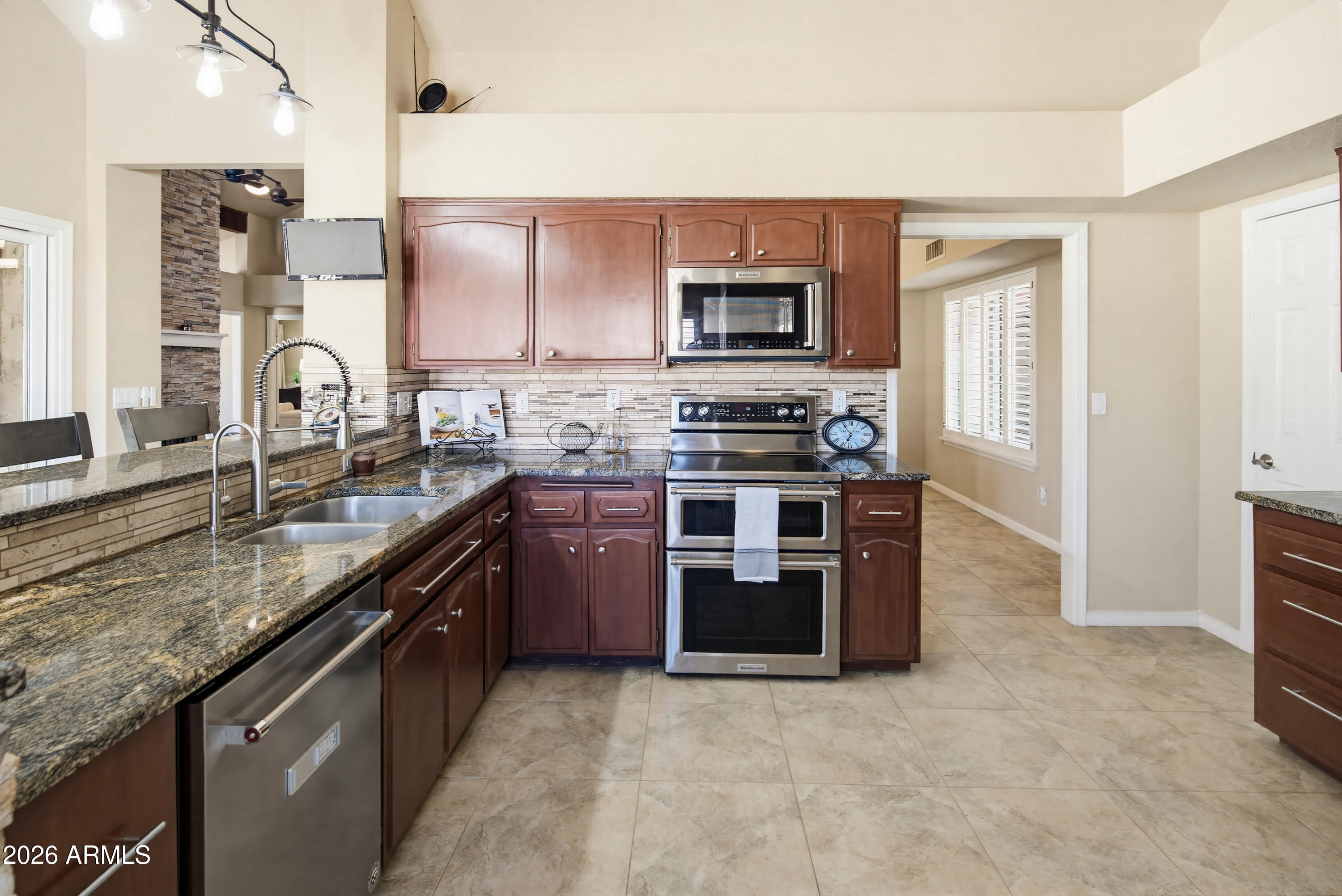 841 North Gentry Mesa, AZ 85213 - Photo 16 of 74 a kitchen with stainless steel appliances granite countertop a stove a sink and a microwave