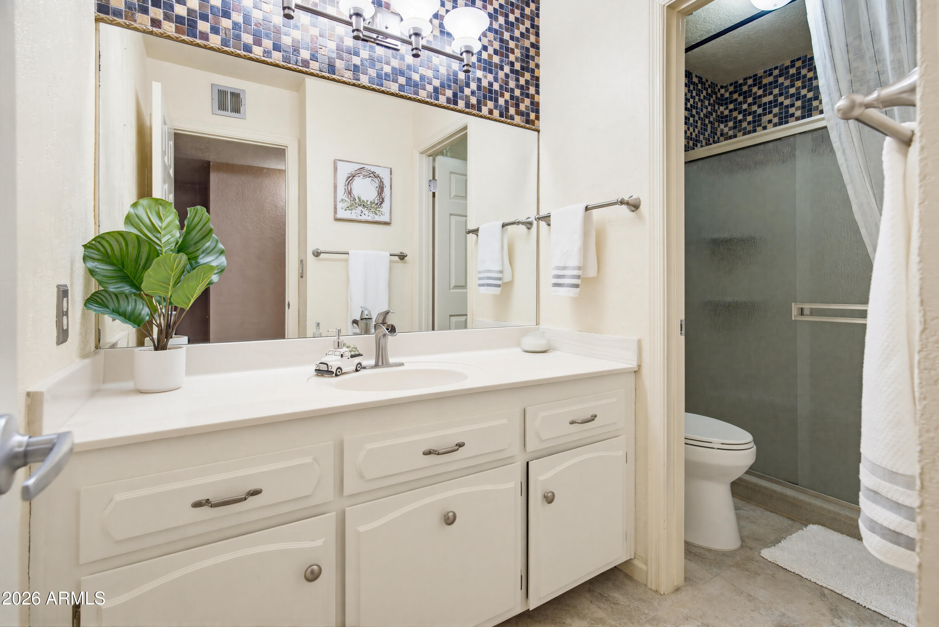 841 North Gentry Mesa, AZ 85213 - Photo 43 of 74 a bathroom with a sink a toilet and a large mirror