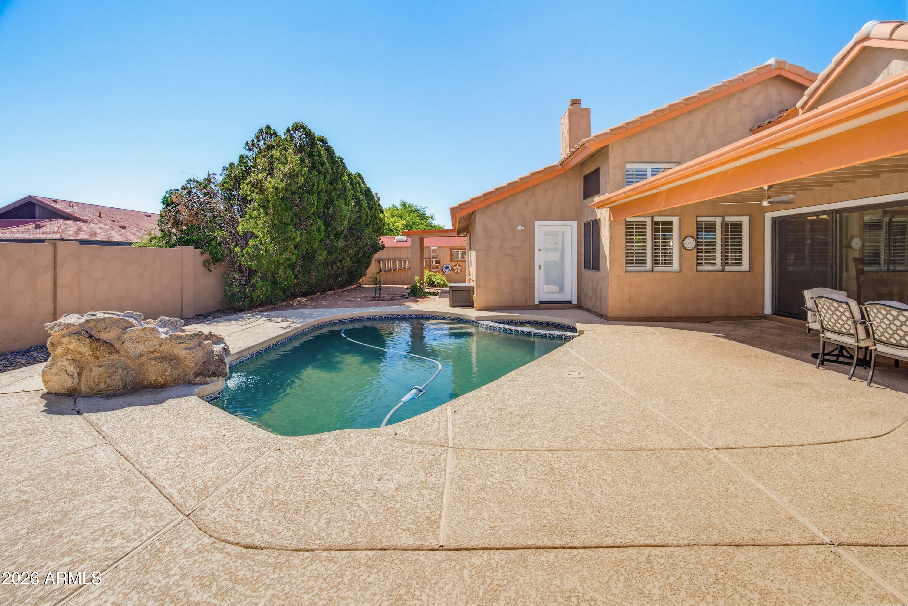 841 North Gentry Mesa, AZ 85213 - Photo 49 of 74 a front view of a house with a garden and outdoor seating