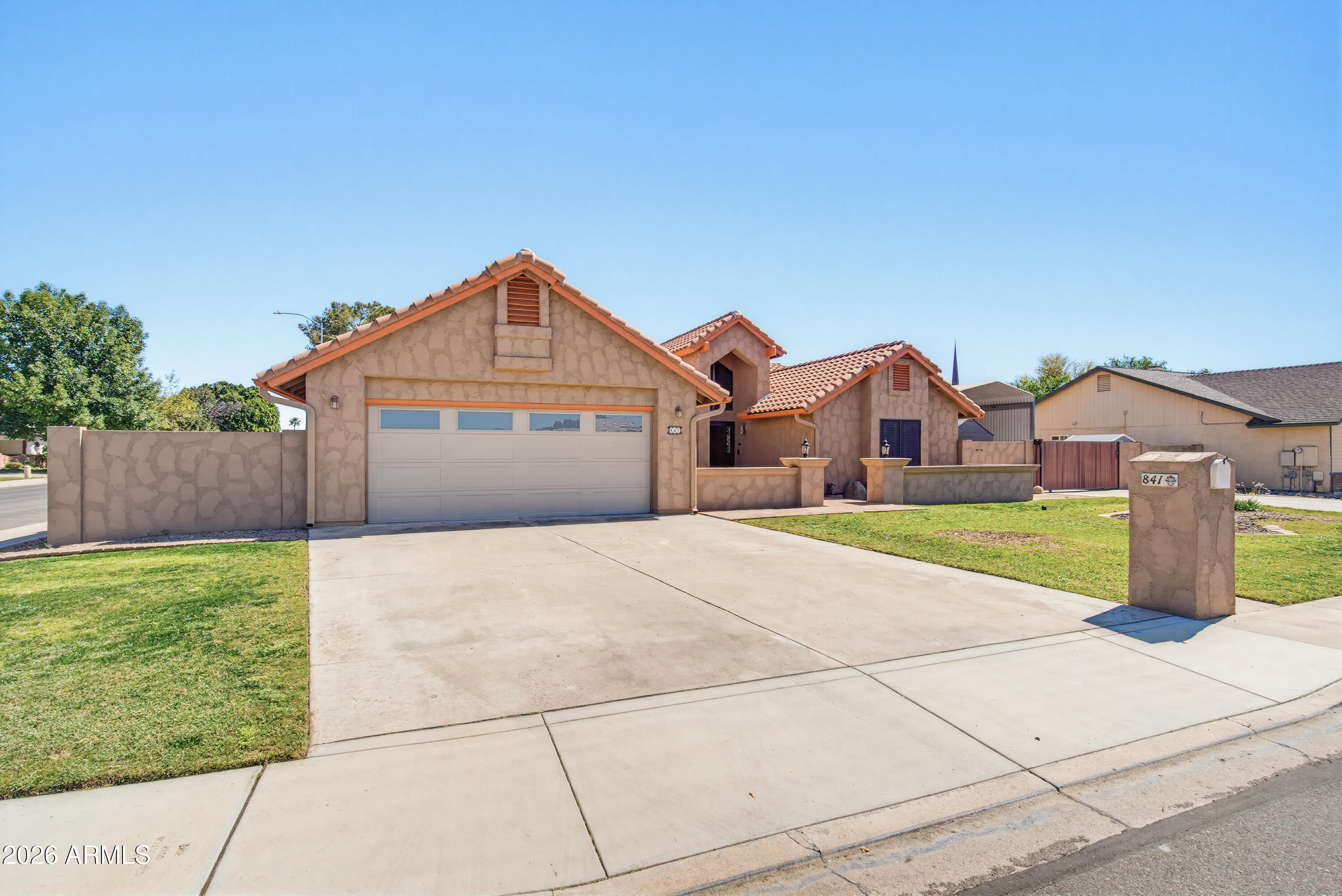 841 North Gentry Mesa, AZ 85213 - Photo 66 of 74 a front view of a house with a yard and garage