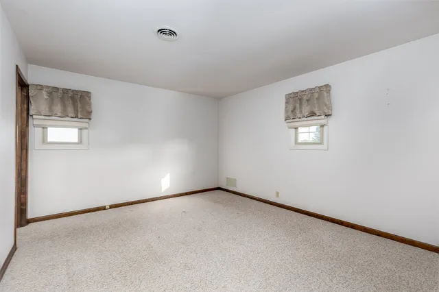 an empty room with a empty space and windows