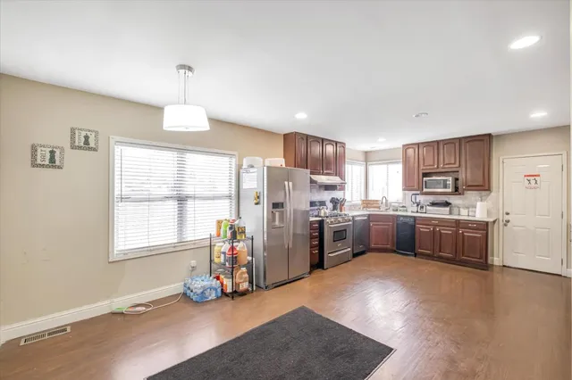 a kitchen with refrigerator a oven and a stove
