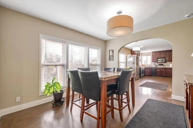 a view of a dining room with furniture window and wooden floor