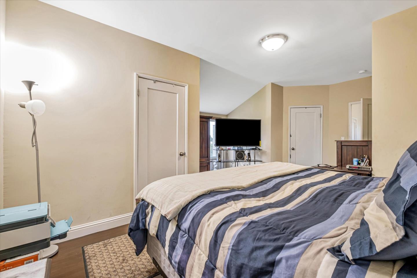 8245 Golf Links Road Oakland, CA 94605 - Photo 28 of 41 a bedroom with a bed and a flat screen tv