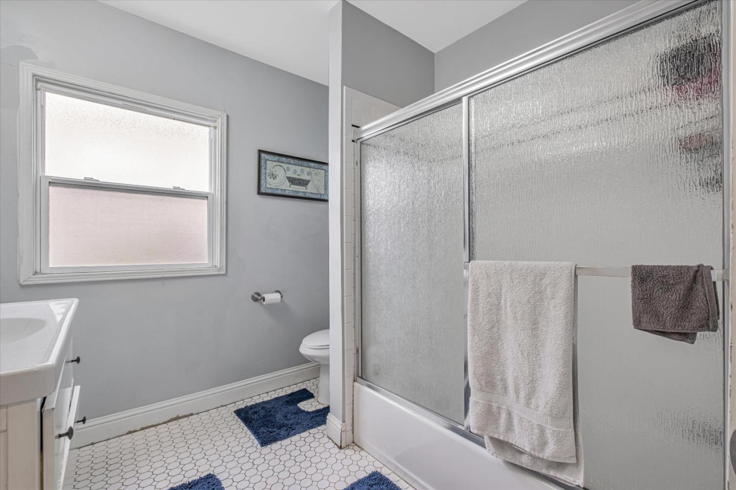8245 Golf Links Road Oakland, CA 94605 - Photo 30 of 41 a bathroom with a granite countertop sink a toilet and shower